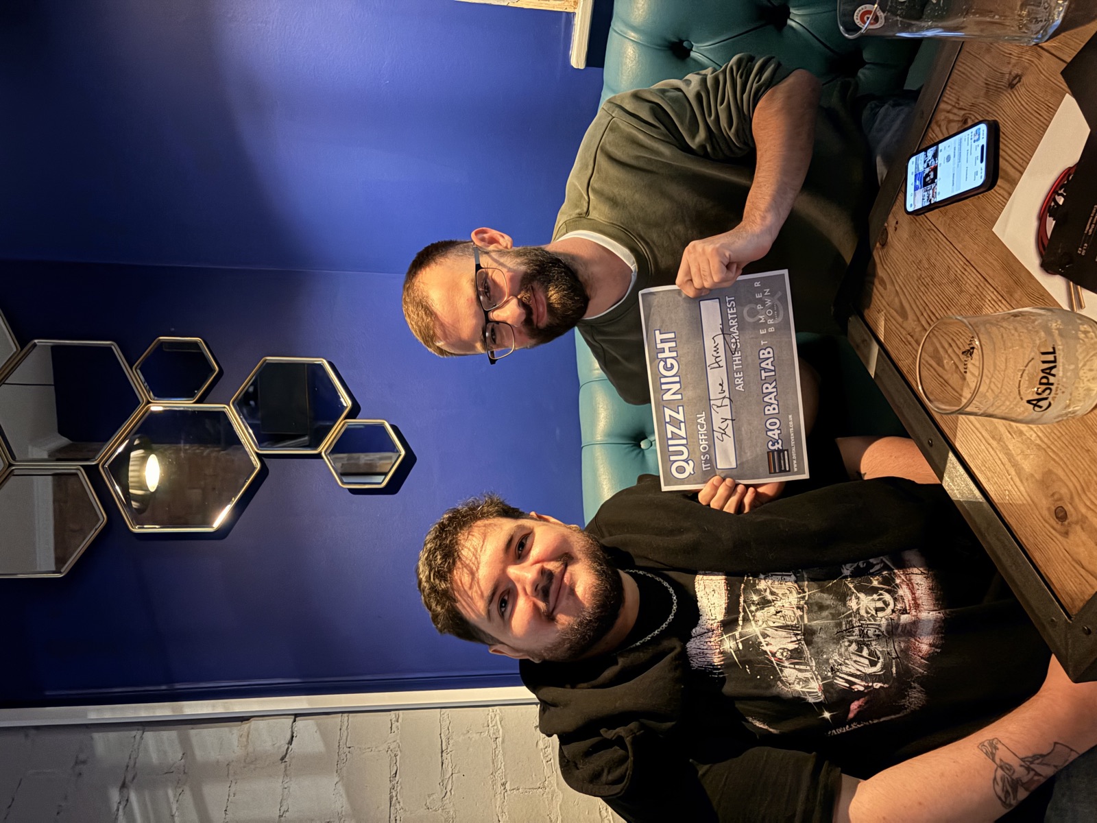 Sky Blue Army holding the £40 bar tab winners' certificate at a Temper & Brown quiz night